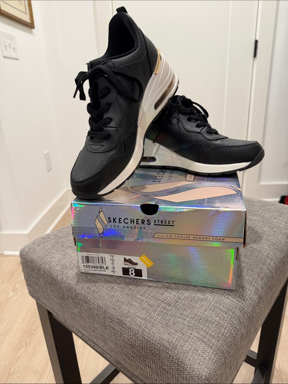 Skechers Black Sneakers with White Midsoles and Gold Accent